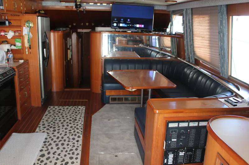 Ocean Eyes Yacht Photos Pics Luxurious interior of a 1994 Mikelson 64 yacht with dining area and modern amenities.