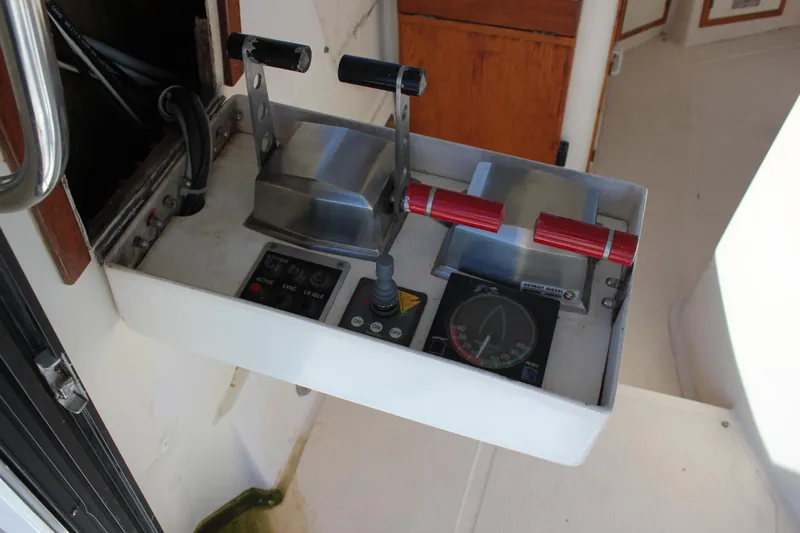 Ocean Eyes Yacht Photos Pics Control panel of a 1994 Mikelson 64 yacht with throttle levers and navigation instruments.