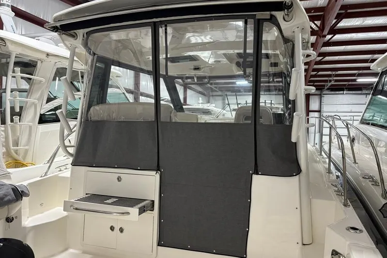  Yacht Photos Pics 2022 Boston Whaler 325 Conquest boat interior with covered seating and storage.