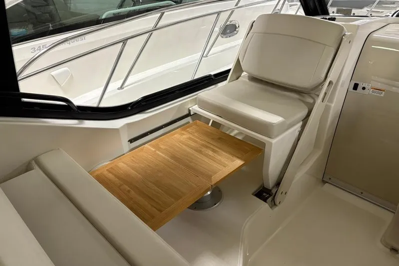  Yacht Photos Pics Interior of 2022 Boston Whaler 325 Conquest with seating and wooden table.