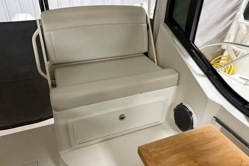  Yacht Photos Pics 2022 Boston Whaler 325 Conquest interior seating with storage and speaker.