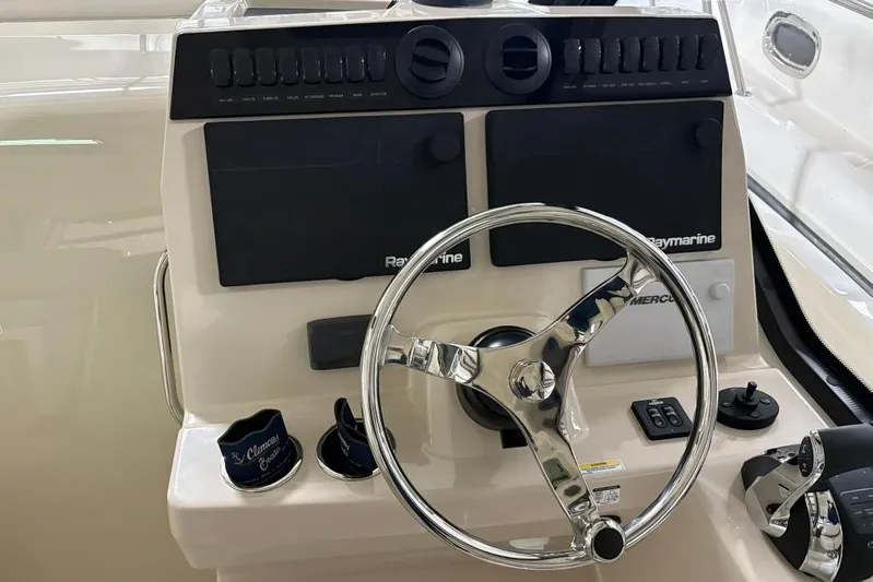  Yacht Photos Pics 2022 Boston Whaler 325 Conquest helm with steering wheel and Raymarine controls.