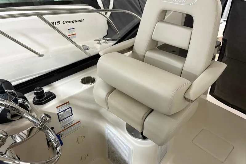  Yacht Photos Pics 2022 Boston Whaler 325 Conquest helm seat and controls, showcasing luxury and functionality.