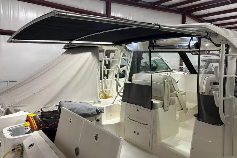  Yacht Photos Pics 2022 Boston Whaler 325 Conquest boat interior with canopy and seating.