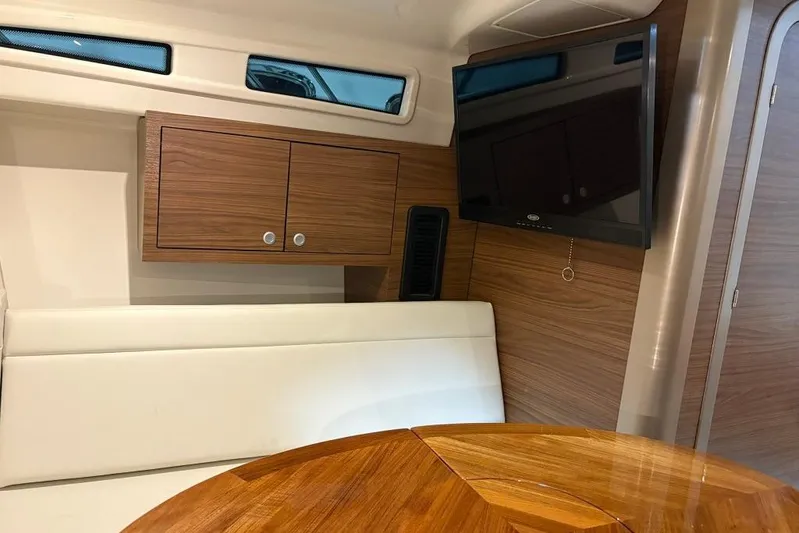  Yacht Photos Pics Interior of 2022 Boston Whaler 325 Conquest, featuring wood cabinetry and a mounted TV.
