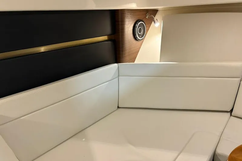  Yacht Photos Pics Interior of 2022 Boston Whaler 325 Conquest, featuring white cushioned seating and modern design elements.