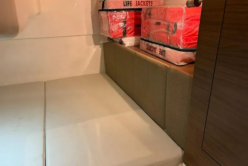  Yacht Photos Pics Interior of 2022 Boston Whaler 325 Conquest with life jackets stored on cushioned seating.