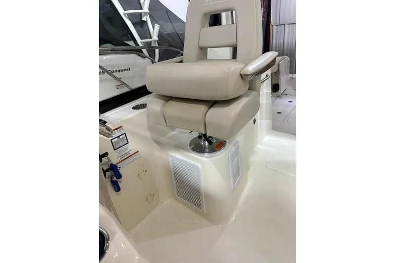  Yacht Photos Pics Captain's chair on 2022 Boston Whaler 325 Conquest boat, featuring beige upholstery and modern design.
