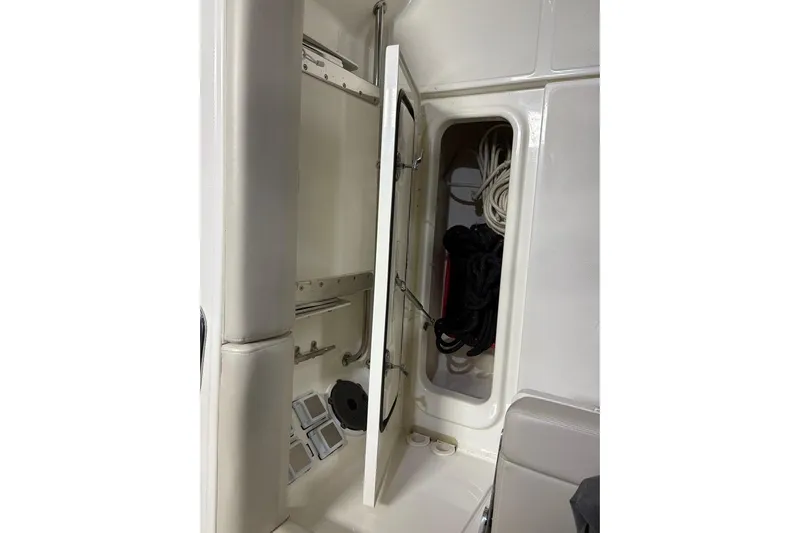  Yacht Photos Pics Interior storage compartment of 2022 Boston Whaler 325 Conquest boat with ropes and equipment.