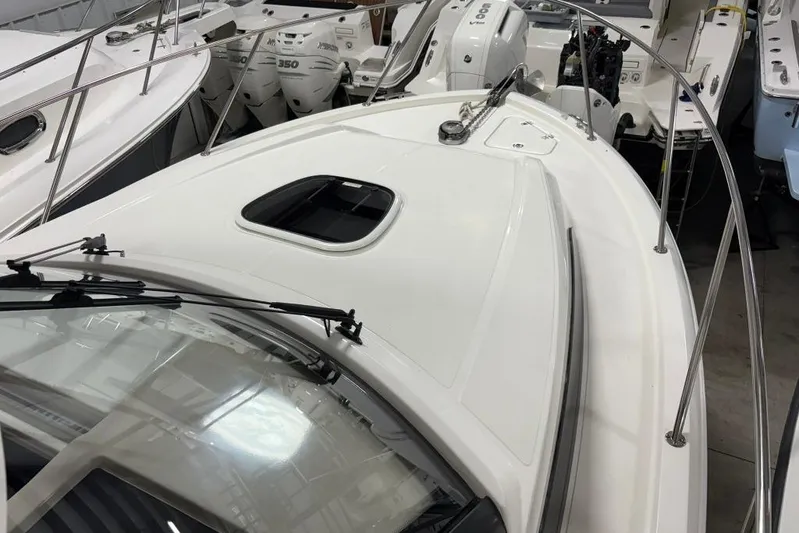  Yacht Photos Pics 2022 Boston Whaler 325 Conquest boat deck with railing and windshield in showroom.
