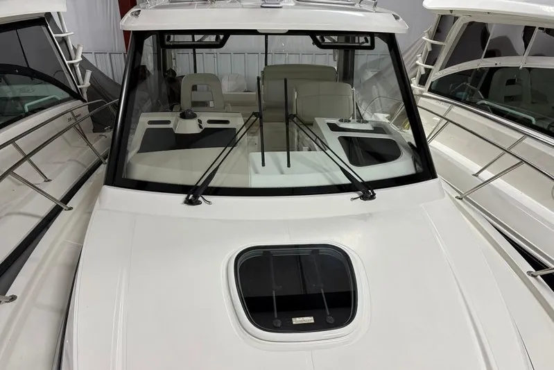  Yacht Photos Pics 2022 Boston Whaler 325 Conquest boat interior with windshield and seating area.
