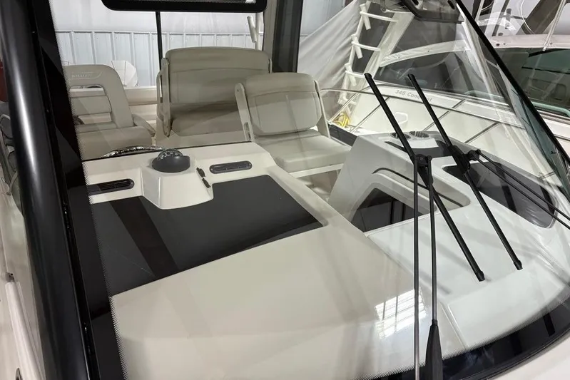  Yacht Photos Pics 2022 Boston Whaler 325 Conquest interior with windshield and seating area.