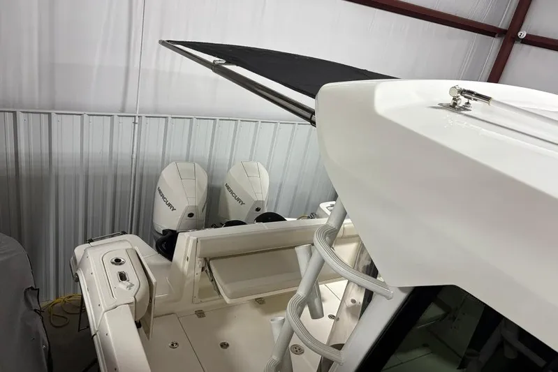  Yacht Photos Pics 2022 Boston Whaler 325 Conquest boat with dual Mercury engines in storage.