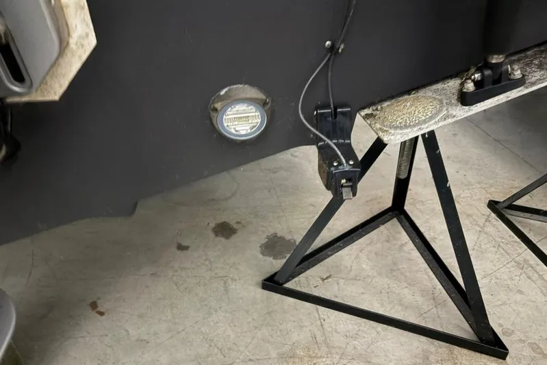  Yacht Photos Pics 2022 Boston Whaler 325 Conquest boat on stands, showing hull and underwater light.