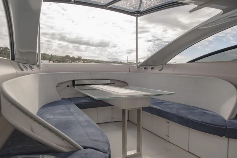 Mercedes Yacht Photos Pics Luxurious interior of 2022 Silver Arrows Marine Arrow 460 GT yacht with modern seating and glass table.