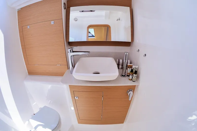  Yacht Photos Pics Modern bathroom interior of 2019 Dufour 460 Grand Large yacht with sleek sink and mirror.