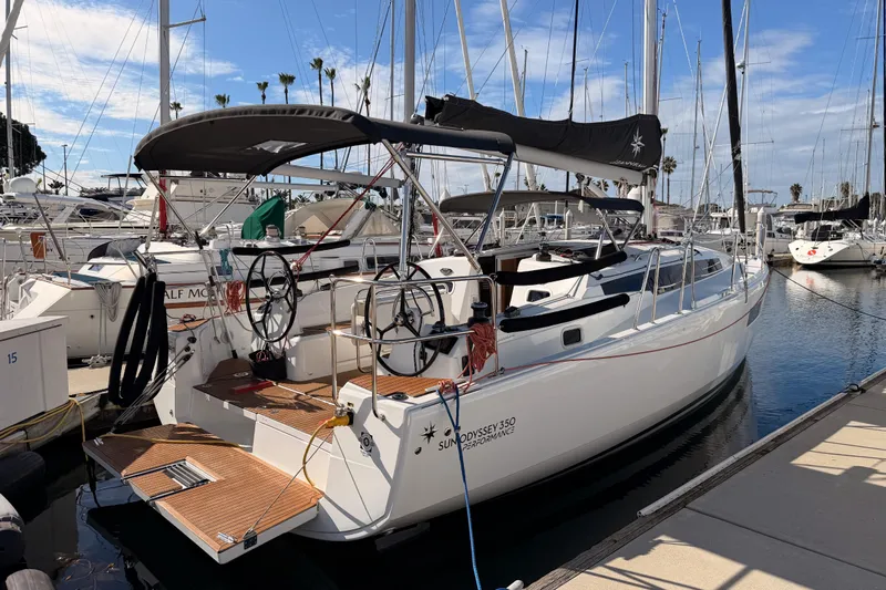 C'est Chic Yacht Photos Pics 2025 Jeanneau Sun Odyssey 350 sailboat docked in marina under clear blue sky.