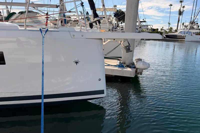 C'est Chic Yacht Photos Pics 2025 Jeanneau Sun Odyssey 350 yacht docked in a marina, side view.