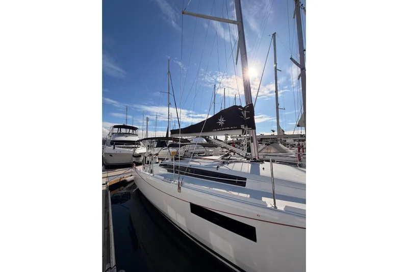 C'est Chic Yacht Photos Pics 2025 Jeanneau Sun Odyssey 350 sailboat docked at marina under clear blue sky.