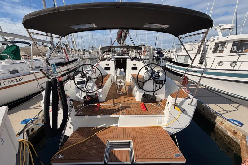 C'est Chic Yacht Photos Pics 2025 Jeanneau Sun Odyssey 350 sailboat with dual steering wheels, docked at marina.
