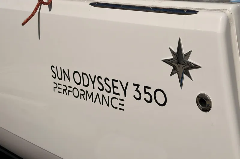C'est Chic Yacht Photos Pics 2025 Jeanneau Sun Odyssey 350 Performance yacht emblem with star design.