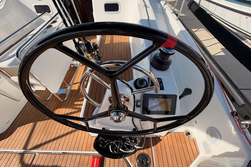 C'est Chic Yacht Photos Pics Steering wheel of 2025 Jeanneau Sun Odyssey 350 sailboat with navigation controls.
