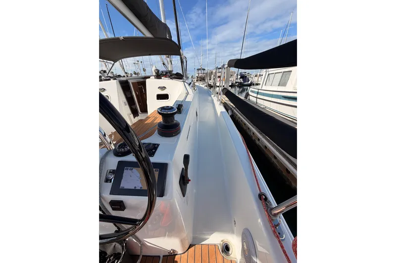 C'est Chic Yacht Photos Pics 2025 Jeanneau Sun Odyssey 350 sailboat cockpit with navigation equipment and marina view.