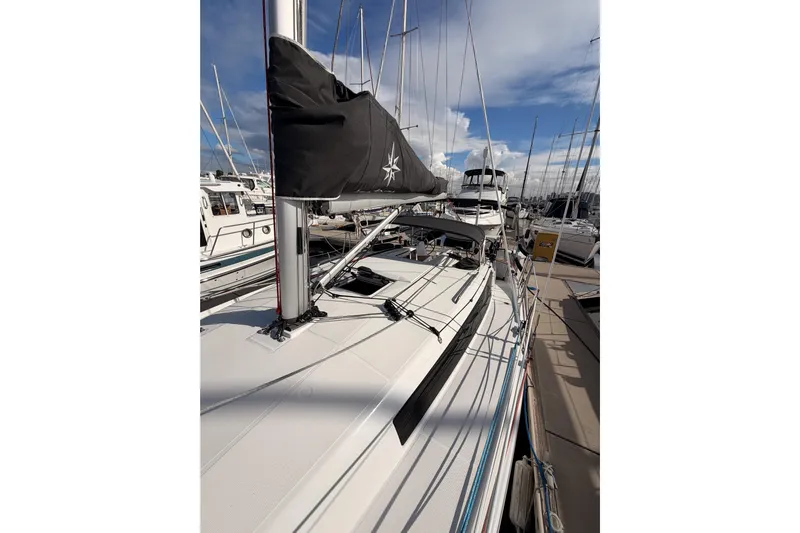 C'est Chic Yacht Photos Pics 2025 Jeanneau Sun Odyssey 350 sailboat docked at marina under blue sky.
