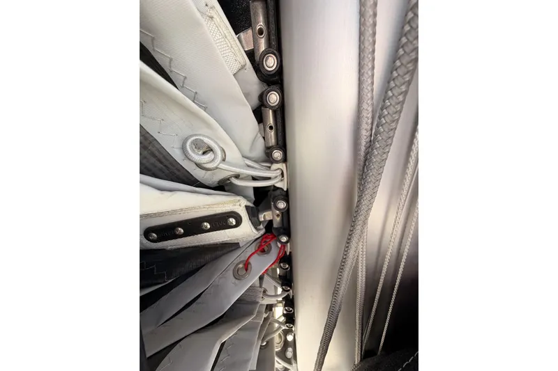 C'est Chic Yacht Photos Pics Close-up of Jeanneau Sun Odyssey 350 sailboat rigging, showcasing detailed sail attachments.