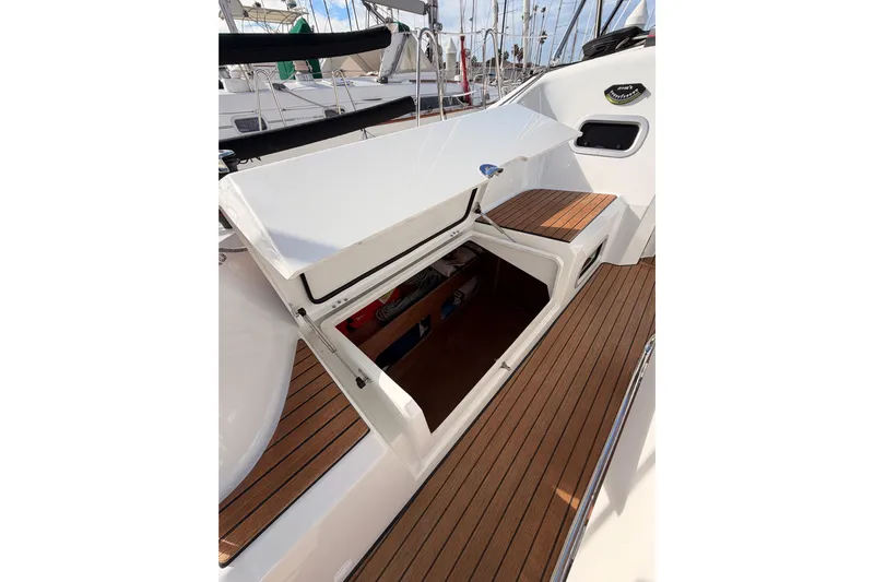 C'est Chic Yacht Photos Pics 2025 Jeanneau Sun Odyssey 350 sailboat with open storage compartment on teak deck.