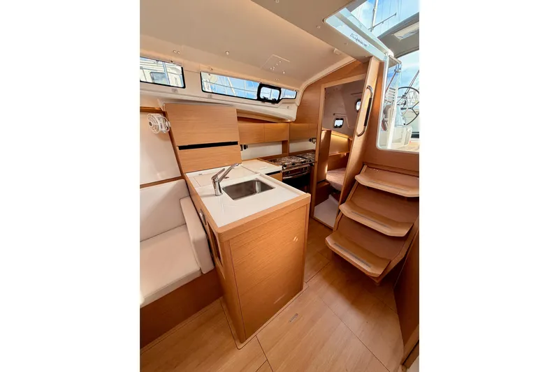 C'est Chic Yacht Photos Pics 2025 Jeanneau Sun Odyssey 350 interior with modern kitchen and wooden finishes.