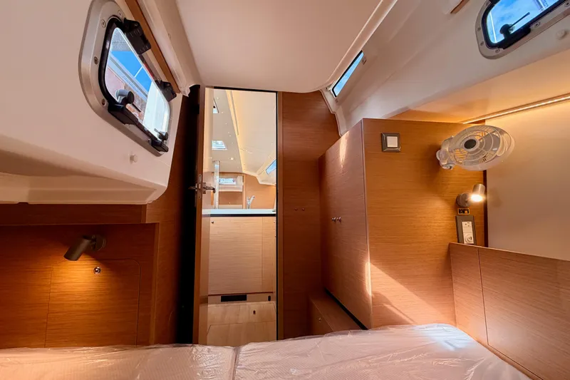 C'est Chic Yacht Photos Pics 2025 Jeanneau Sun Odyssey 350 cabin interior with modern wood finish and natural light.