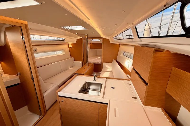 C'est Chic Yacht Photos Pics Interior of 2025 Jeanneau Sun Odyssey 350 yacht, featuring modern kitchen and seating area.