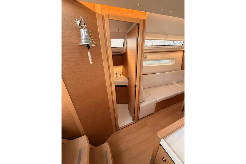 C'est Chic Yacht Photos Pics Interior of 2025 Jeanneau Sun Odyssey 350 yacht with modern wood finish and seating.