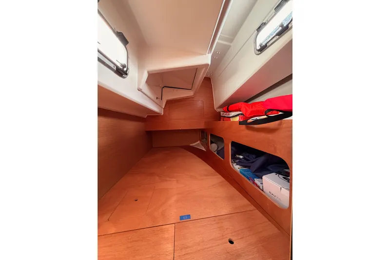 C'est Chic Yacht Photos Pics 2025 Jeanneau Sun Odyssey 350 interior cabin with wooden finish and storage compartments.
