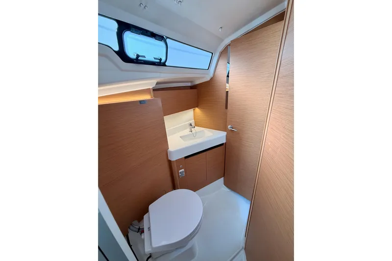C'est Chic Yacht Photos Pics Modern bathroom interior of 2025 Jeanneau Sun Odyssey 350 yacht, featuring sleek design and wood accents.