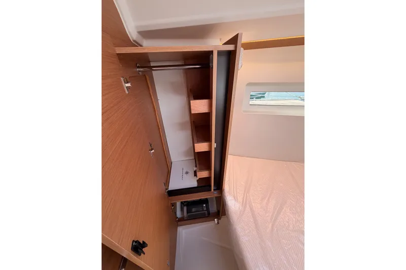 C'est Chic Yacht Photos Pics Interior view of 2025 Jeanneau Sun Odyssey 350 yacht cabin with wooden storage.
