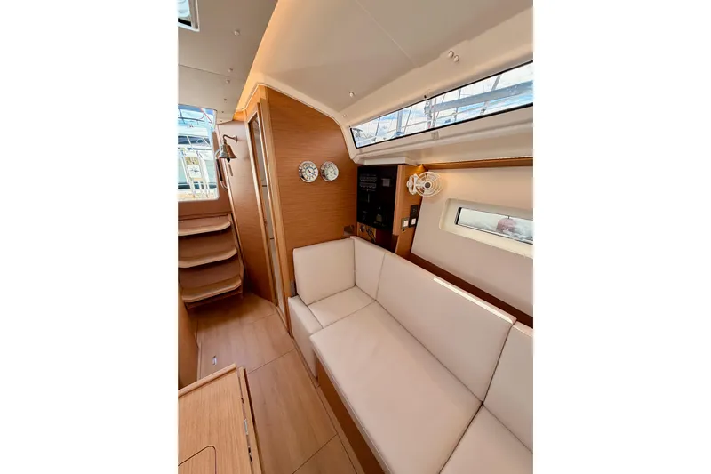 C'est Chic Yacht Photos Pics 2025 Jeanneau Sun Odyssey 350 interior with modern wood finish and comfortable seating.