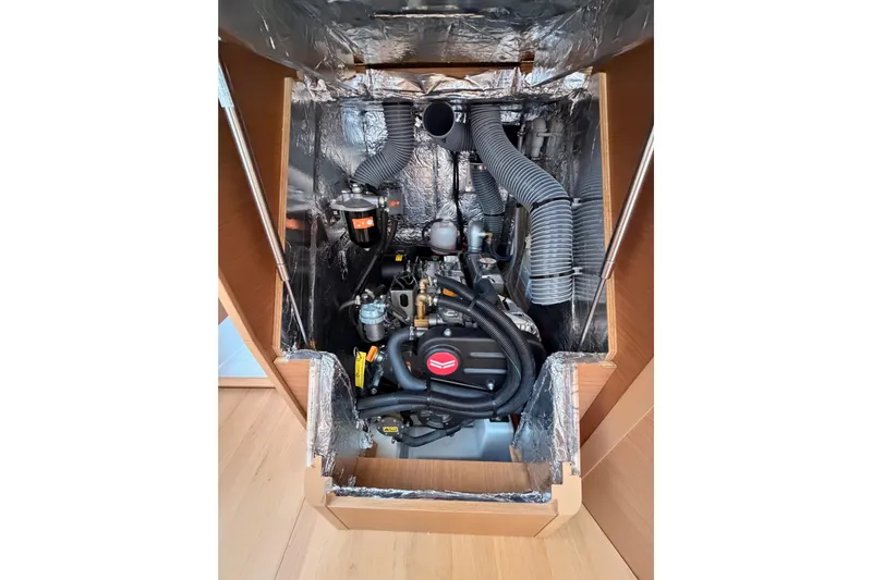 C'est Chic Yacht Photos Pics Engine compartment of 2025 Jeanneau Sun Odyssey 350 sailboat, showcasing mechanical components.