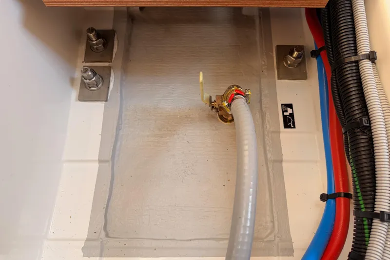 C'est Chic Yacht Photos Pics Interior view of Jeanneau Sun Odyssey 350 yacht, showcasing plumbing and wiring components, 2025 model.