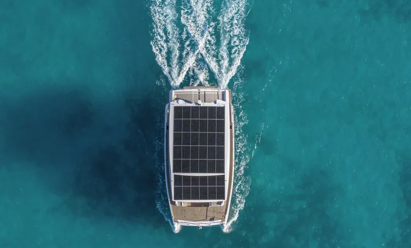  Yacht Photos Pics Aerial view of Silent 62 yacht with solar panels cruising in clear blue water, 2026 model.