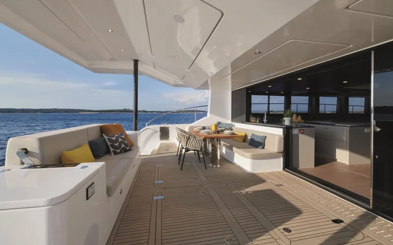  Yacht Photos Pics Luxurious 2026 Silent 62 yacht deck with elegant seating and ocean view.