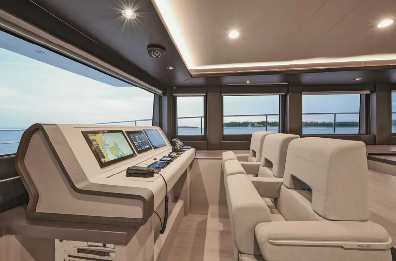  Yacht Photos Pics Luxurious interior of 2026 Silent 62 yacht with modern navigation equipment and plush seating.