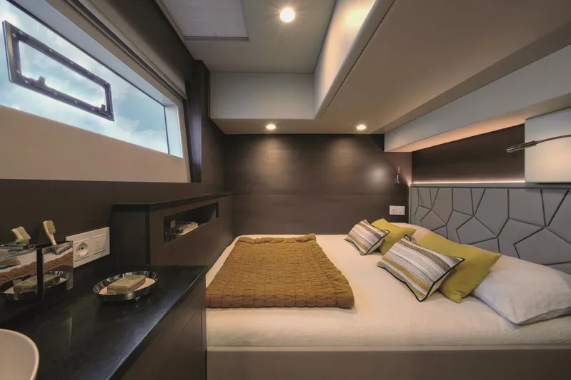 Yacht Photos Pics Luxurious bedroom interior in Silent 62 yacht, 2026 model, featuring modern design and cozy bedding.