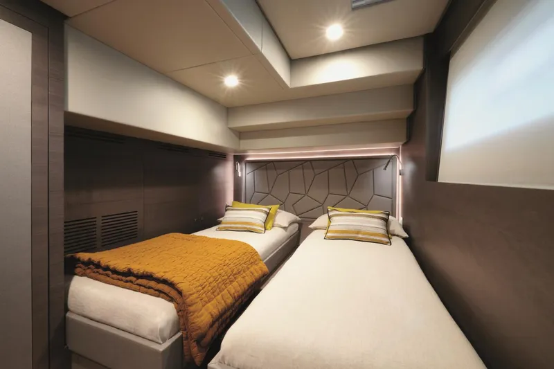  Yacht Photos Pics Luxurious twin bedroom in 2026 Silent 62 yacht, featuring modern design and cozy lighting.