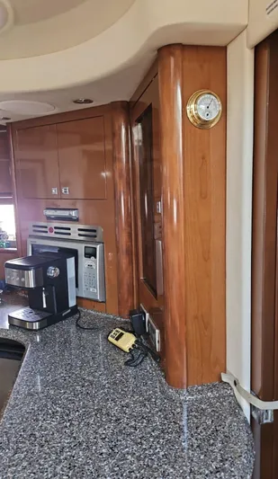 Marcello Yacht Photos Pics Luxurious 2008 Sea Ray Sundancer yacht interior with modern kitchen appliances and elegant wood finish.