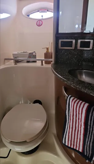 Marcello Yacht Photos Pics 2008 Sea Ray Sundancer bathroom with toilet, sink, and striped towel.