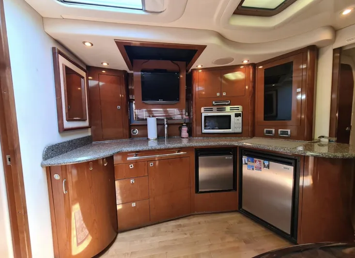 Marcello Yacht Photos Pics Luxurious 2008 Sea Ray Sundancer yacht kitchen with modern appliances and wood cabinetry.