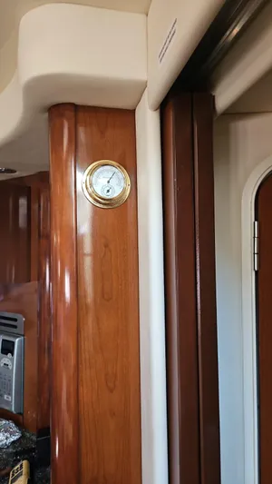 Marcello Yacht Photos Pics Interior of 2008 Sea Ray Sundancer yacht with wooden paneling and a mounted gauge.