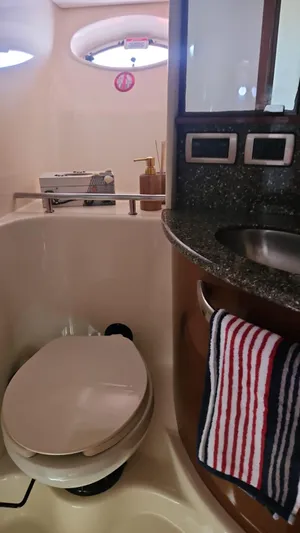 Marcello Yacht Photos Pics 2008 Sea Ray Sundancer bathroom with toilet, sink, and striped towel.